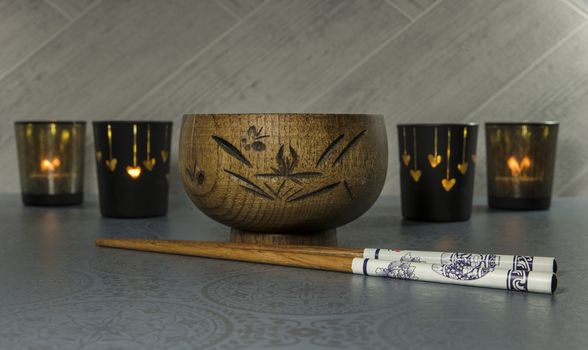 japanese or chines chopsticks with bamboo wooden rice bowl and light at the background