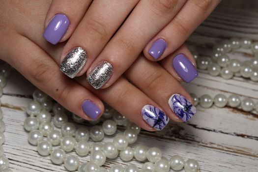 beautiful gray shiny manicure on a trendy texture background