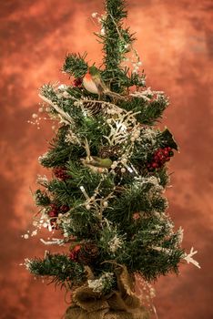 Christmas decoration hanging on a tree covered with snow. Focus on a decoration. Christmas tree.