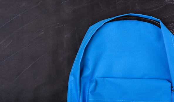 Back to school shopping pocket backpack on the education blue bag on blackboard and chalkboard