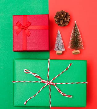 New Year, Christmas Xmas holiday composition, Top view with gift box, clews of rope, green fir tree branch on red and green background with copy space