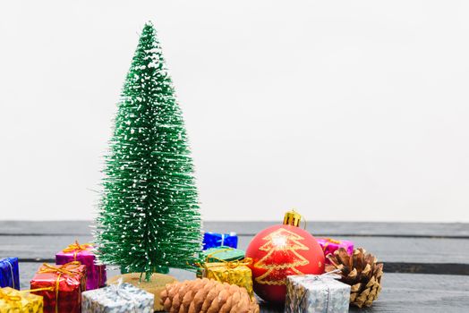 Christmas composition decorations, minimal green fir tree branches with snow and gift boxs on white background. Merry Christmas concept. Copy space for text