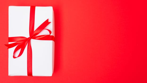 Happy New Year and Christmas 2020 or valentine day, top view Xmas white gift box on red background with copy space for your text