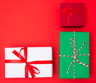 Happy New Year and Christmas 2020 day, top view Xmas multi color gift boxes on red background with copy space for your text
