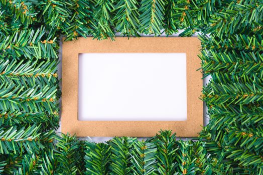 Happy New Year and Christmas day, top view flat lay composition decoration branches tree photo frame on white background with copy space for your text