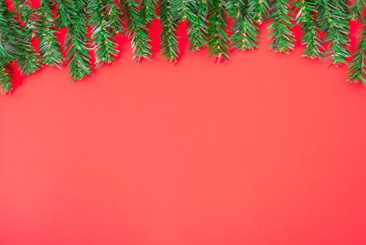 Happy New Year and Christmas day, top view flat lay composition decoration tree fir on red background with copy space for your text