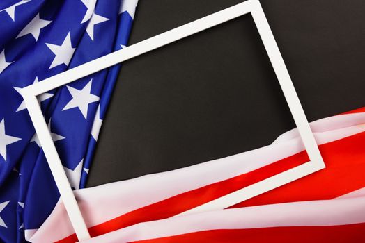 Martin luther king day, flat lay top view, American flag and photo frame on black background with copy space for your text