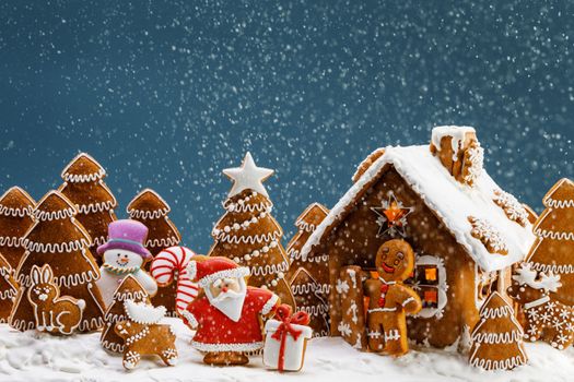 Gingerbread house christmas fir trees Santa Claus and gift cookies winter holiday celebration concept
