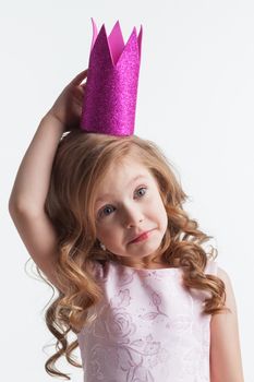 Little princess girl in pink dress and crown , studio isolated on white background