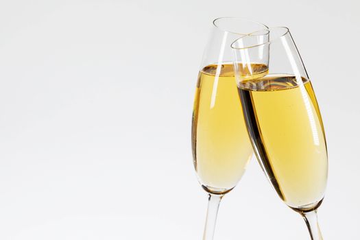 Two glasses of champagne on white background