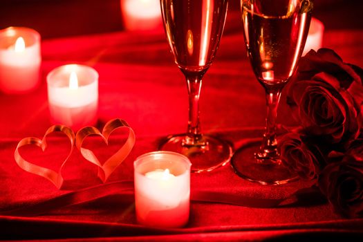 Valentines day background with champagne glasses candles and hearts