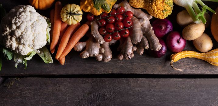 Harvest of many various colorful vegetables on wooden background