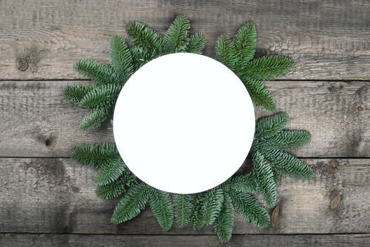 Christmas circle frame of natural fir tree branches with copy space for text