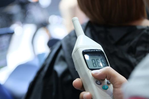 The Measuring the noise of event in the hall with a sound level meter.