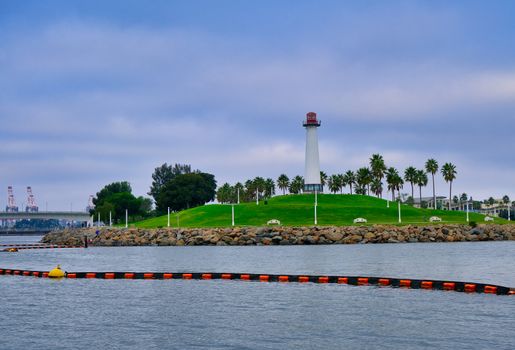 Lighthouse in Long Beach with Debris Barrier in Harbor
