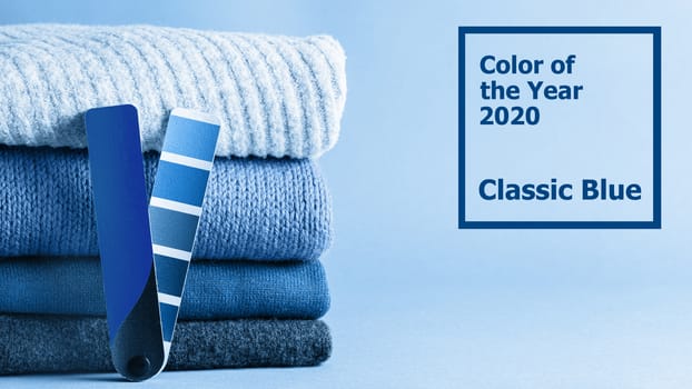 Stack of sweaters and color fun palette in classic blue 2020 color. Color of year 2020 concept for fashion and clothing industry. Banner