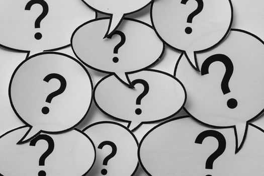 Full frame background of speech bubbles with question marks in a random overlap conceptual of communication, problems, dialogue, and confusion