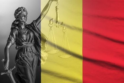 Figure of Justice with scales over a Belgian flag in a concept of law and order and legal impartiality