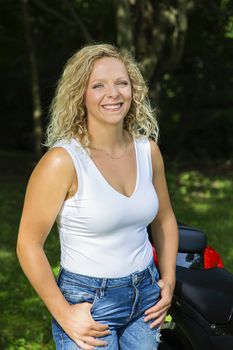 Portrait of a mid-twenties woman, wearing a tank top and jeans