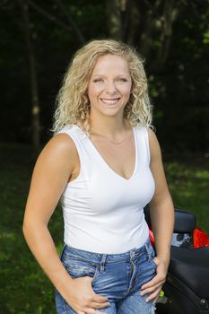Portrait of a mid-twenties woman, wearing a tank top and jeans