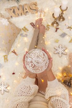 A woman holds Christmas decorations for the home