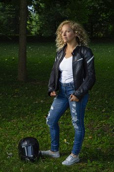 twenty something blond woman wearing motocycling attire