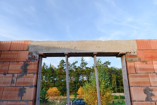 Interior of a Unfinished Red Brick House Walls under Construction without Roofing.