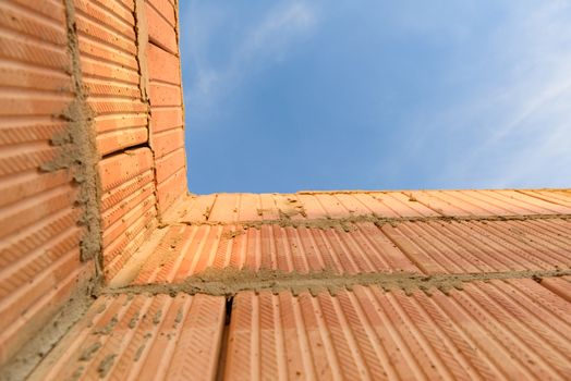 Interior of a Unfinished Red Brick House Walls under Construction without Roofing.