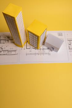Yellow paper block of flats on yellow background paper. Minimalistic and simple concept, style. Copy space. Horizontal orientation.