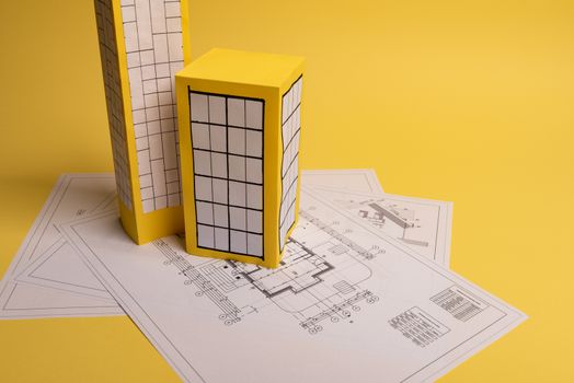 Yellow paper block of flats on yellow background paper. Minimalistic and simple concept, style. Copy space. Horizontal orientation.