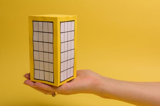 Yellow paper block of flats on yellow background paper. Minimalistic and simple concept, style. Copy space. Horizontal orientation.