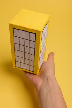 Yellow paper block of flats on yellow background paper. Minimalistic and simple concept, style. Copy space. Horizontal orientation.