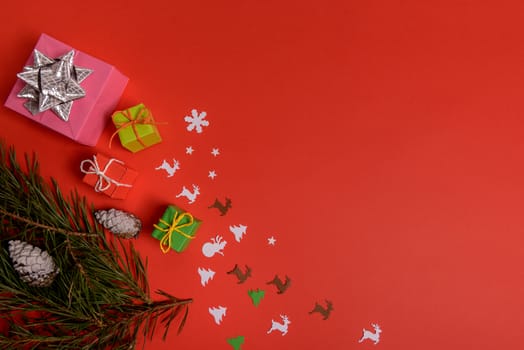 Christmas or New Year background, plain composition made of Xmas decorations and fir branches, flat lay, blank space for a greeting text.