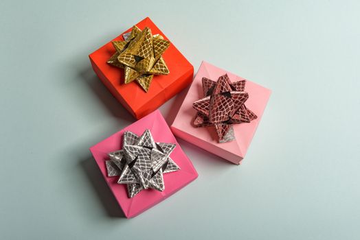 christmas presents nicely decorated with bows and feathers. view from above