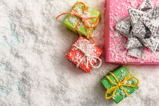 christmas presents nicely decorated with bows and feathers. view from above