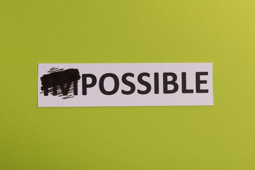 Impossible text cut out. Possible concept. Success. Pink background. Copy space. Vertical orientation. View from above. Minimal simple style