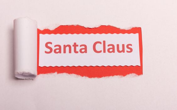 White torn paper with Santa Claus text with red background color. Hidden message. Secret. Copy space
