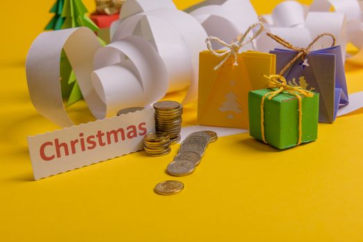 Holiday expenses concept. Long twisted christmas expenses list, presents, gifts, money coins and christmas text
