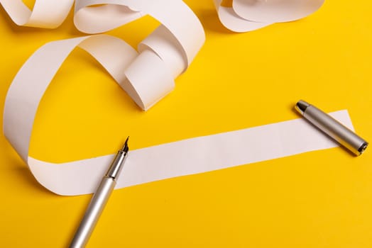 Long twisted expanded empty letter. Copy space. yellow background. View from above