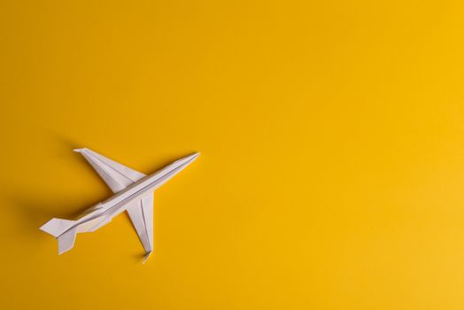 Group of paper plane in one direction and with one individual pointing in the different way on yellow background. Business for innovative solution concept. Dotted line from aircraft tail.