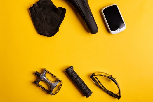 Bicycle, Cycling accessories on the yellow background. view from above