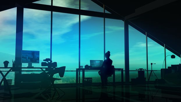 In the studio with panoramic windows, the silhouette of a female videographer at the computer.