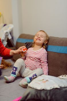 Portrait of 14 months old baby with nipple in bedroom