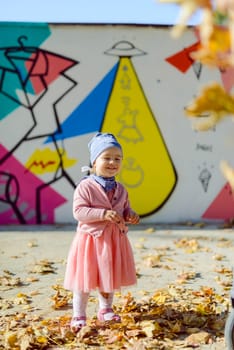 Adorable girl having fun on beautiful autumn day.
