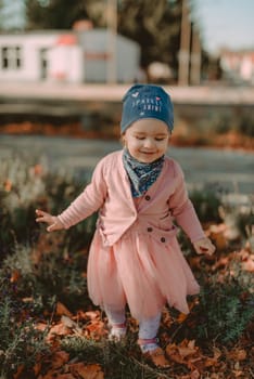 Adorable girl having fun on beautiful autumn day.