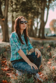 Autumn attractive woman portrait smiling outdoors at the park. Authentic and natural photographs