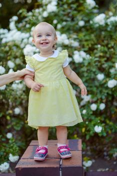Smiling girl in the park in summer time. Authentic lifestyle image
