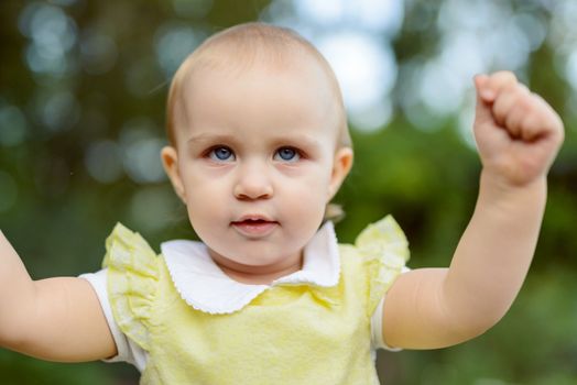 Smiling girl in the park in summer time. Authentic lifestyle image