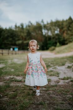 Smiling girl in the park in summer time. Authentic lifestyle image