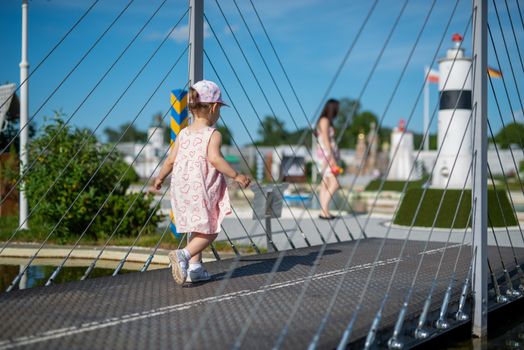 Little girl spending fantastic time on playground. Happy childhood.